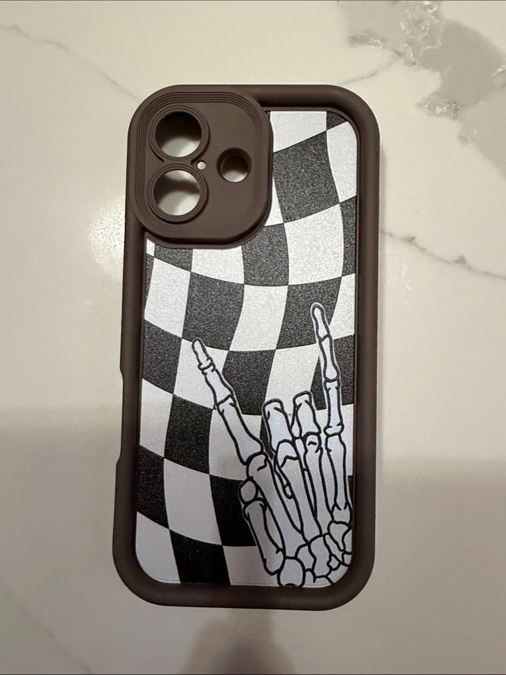 Brown Checkerboard Skeleton Hand iPhone 17 Case